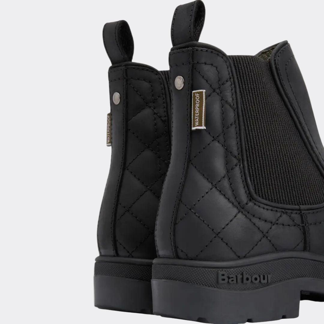Black quilted boots with a visible brand logo on a white background