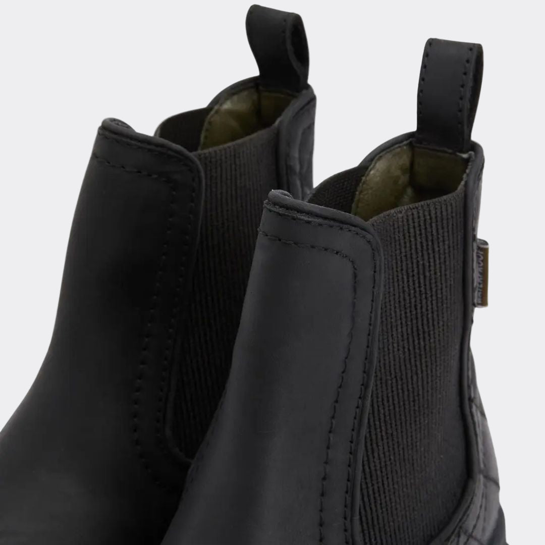 Pair of black leather boots with a white background