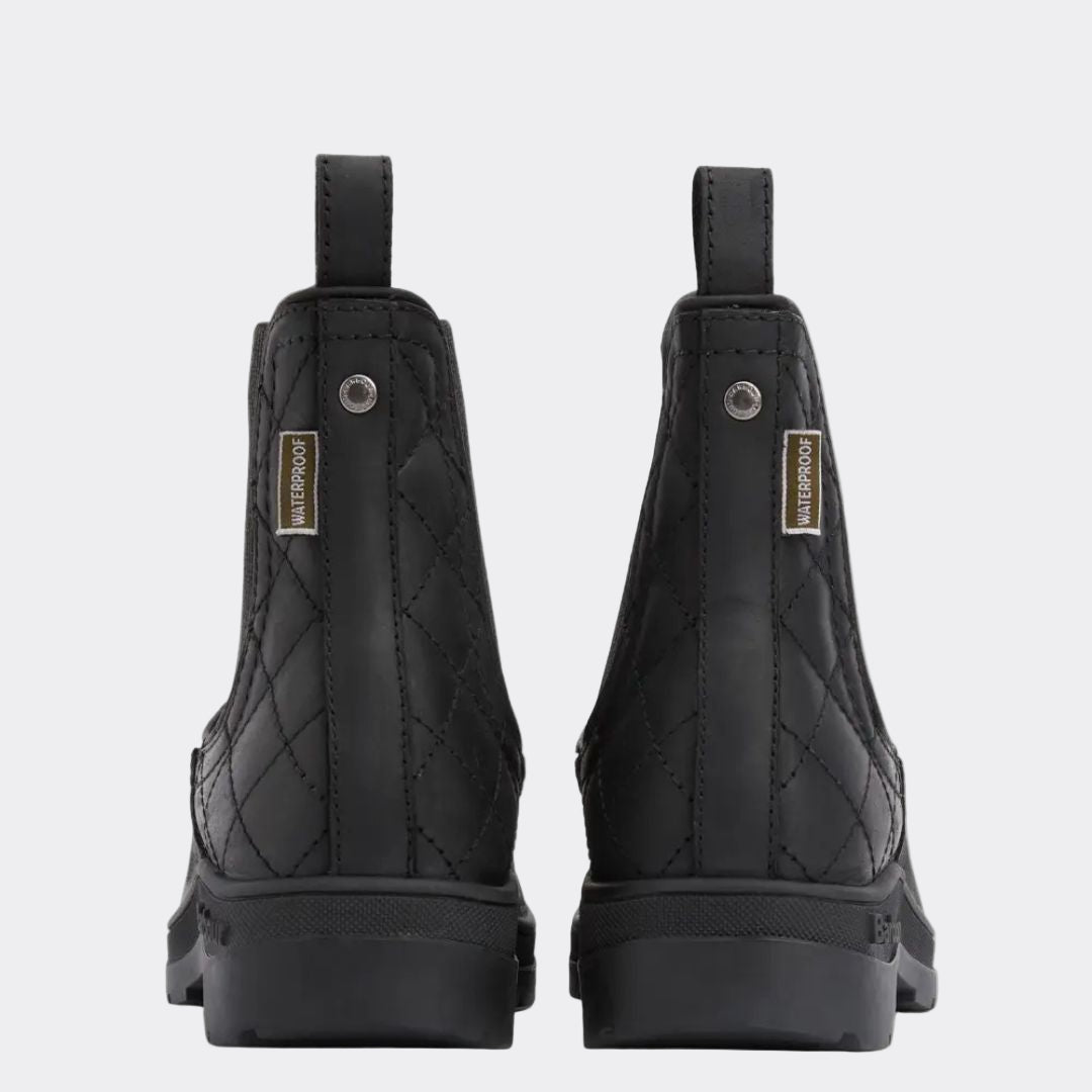 Pair of black riding boots with quilted design on a white background