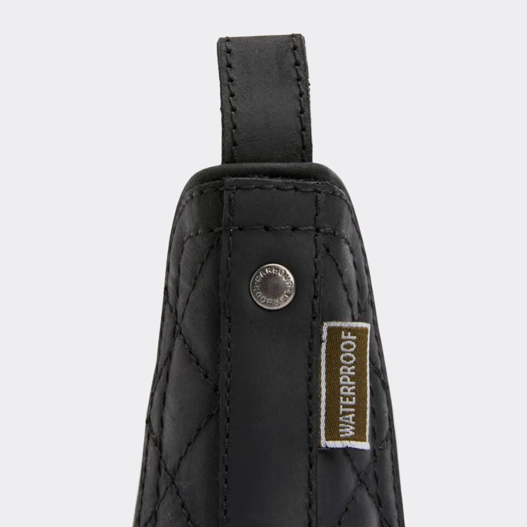 Black quilted pouch with a waterproof label on a white background