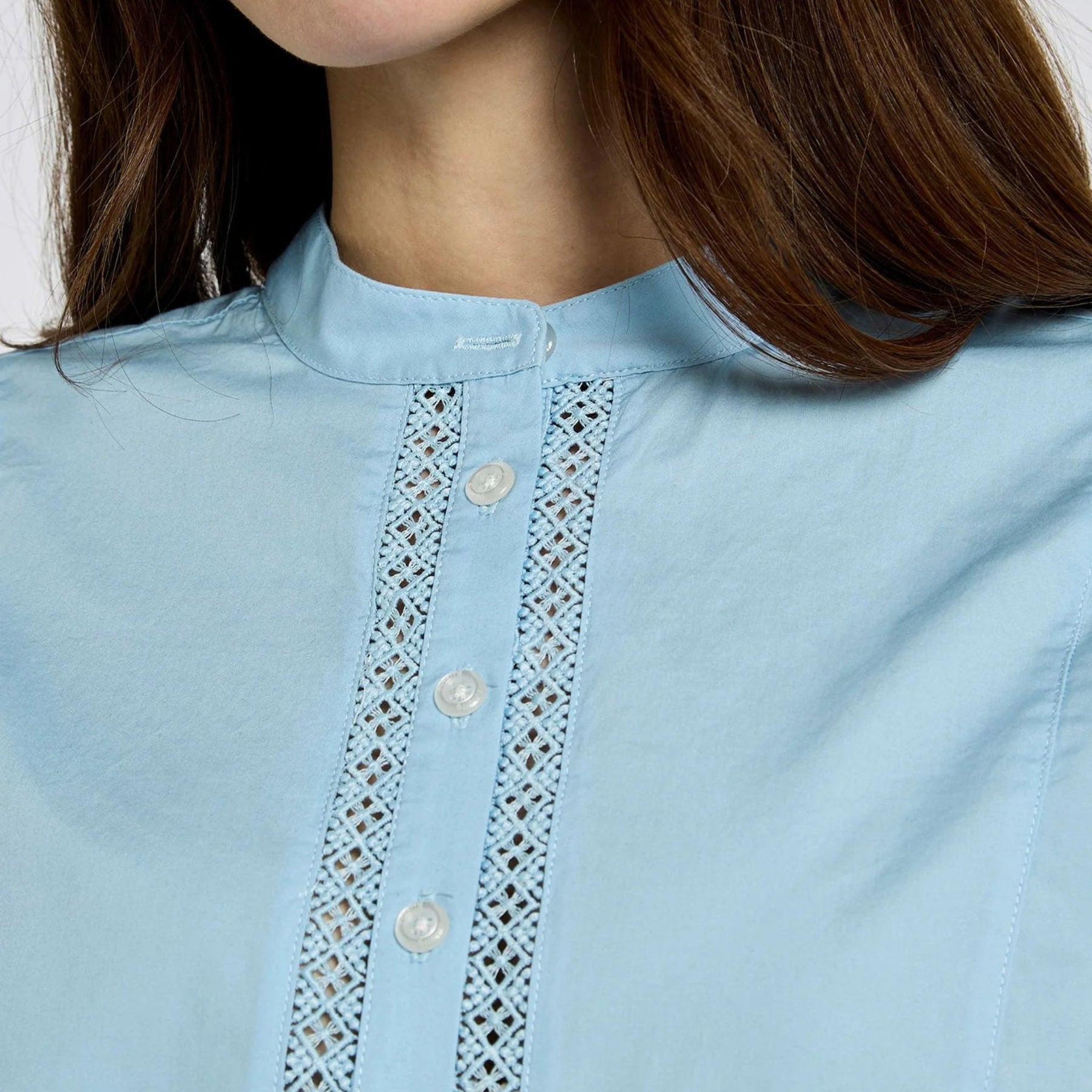 Light blue shirt with lace detailing on a person