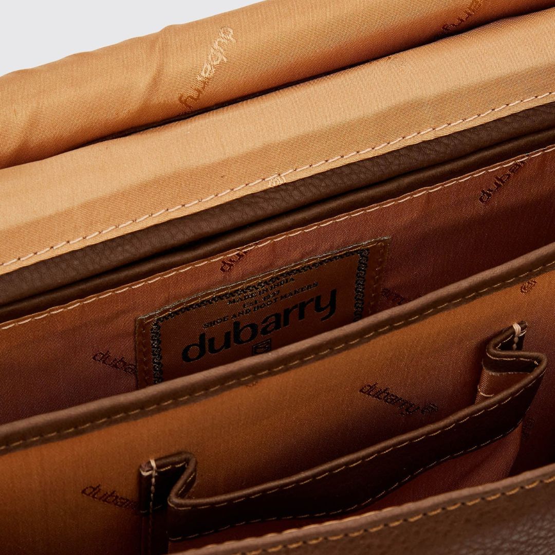 Close-up of a brown leather bag with 'Dubarry' branding.