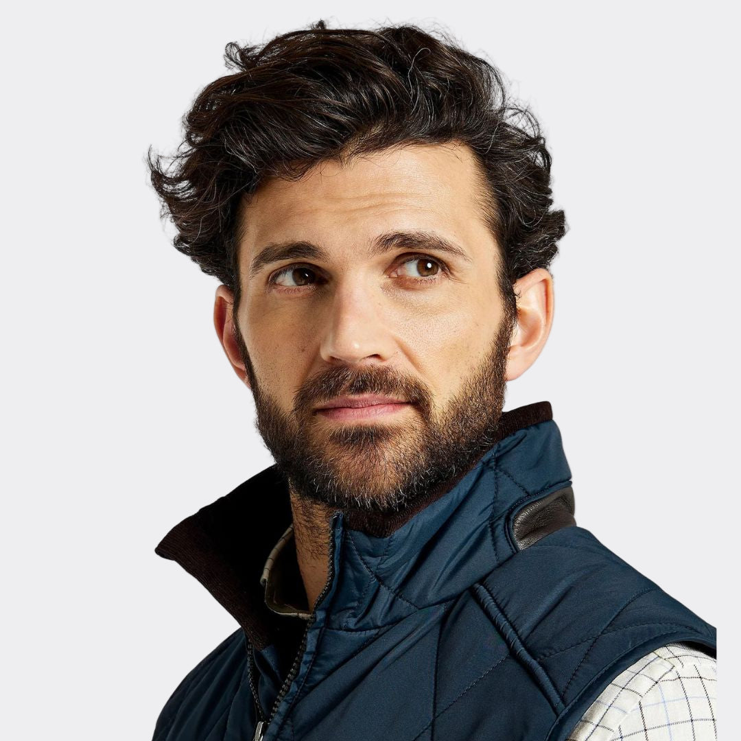Man wearing a blue vest on a white background