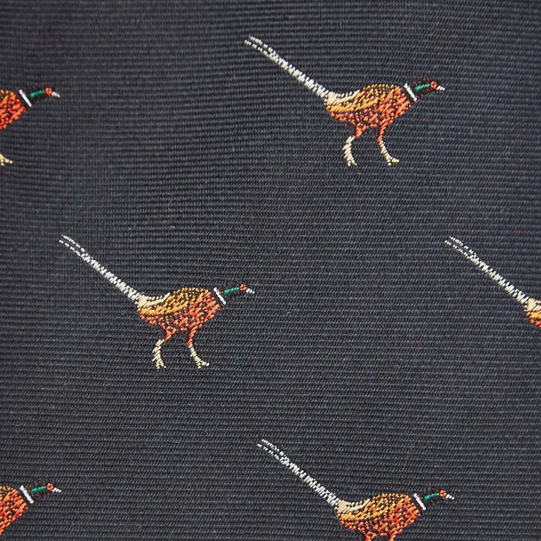 Patterned tie with pheasant designs on a dark background