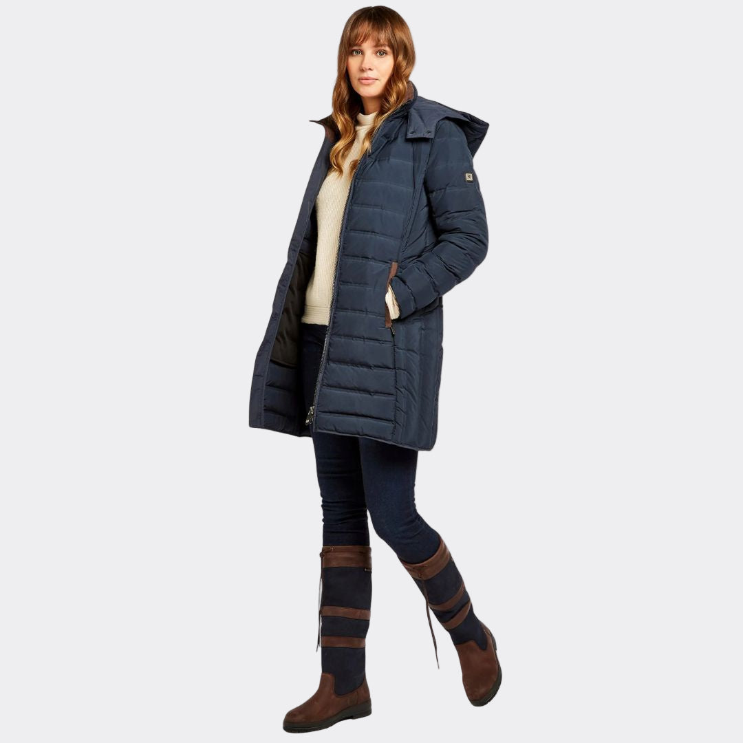 Woman wearing a blue puffer coat on a white background