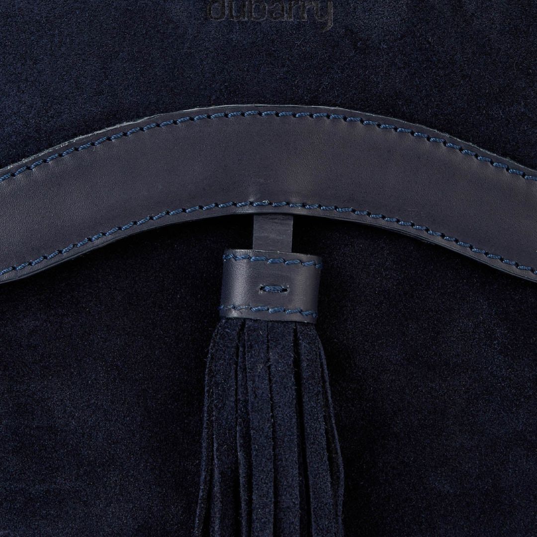 Navy blue leather belt with tassel on a dark background