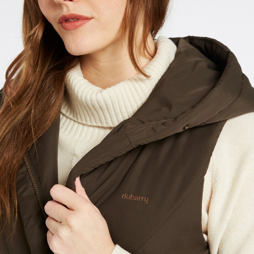 Brown hooded jacket with 'Dubarry' branding worn by a person on a white background