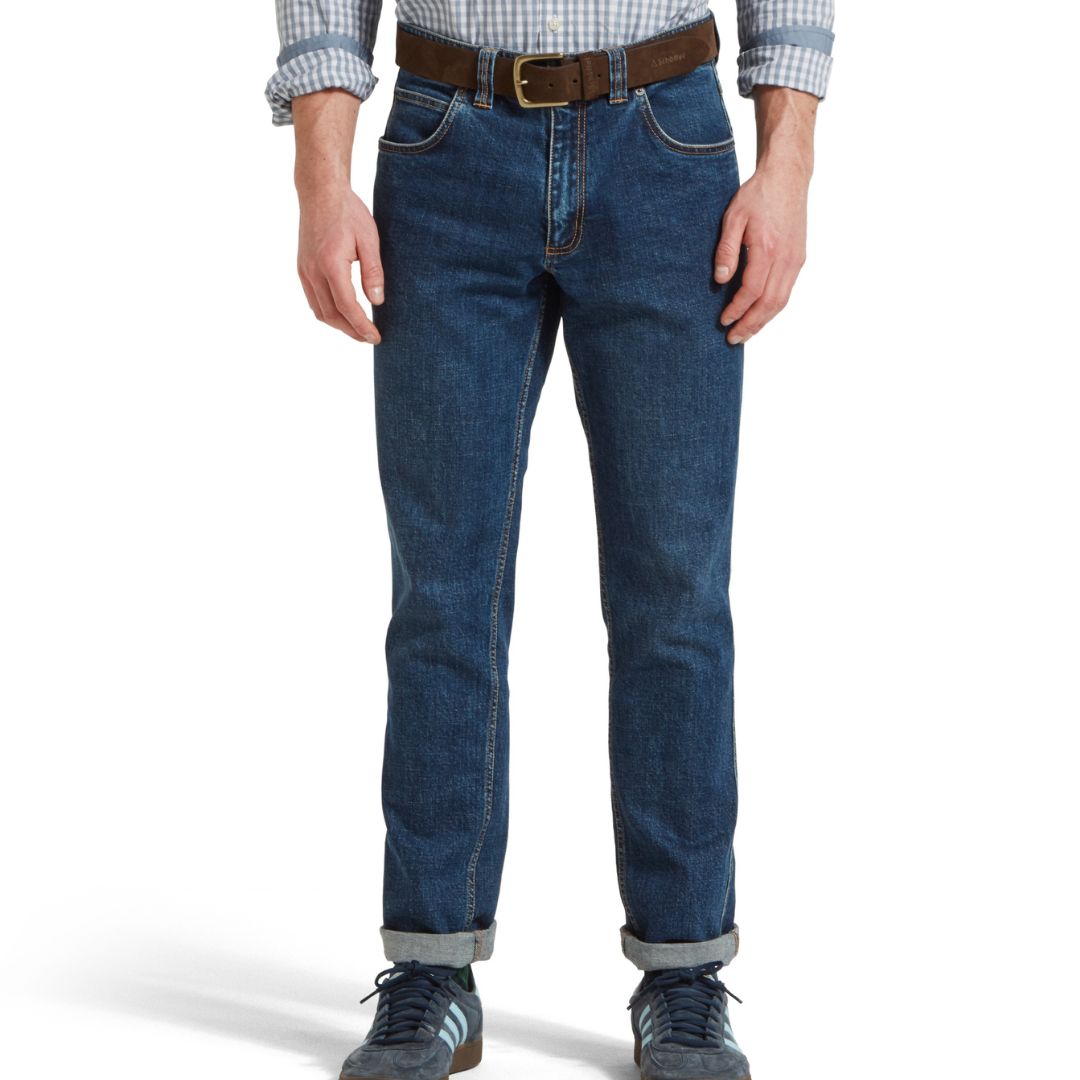 Person wearing blue jeans with a white background