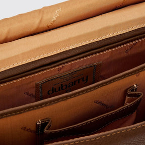 Close-up of a brown leather bag with 'Dubarry' branding.