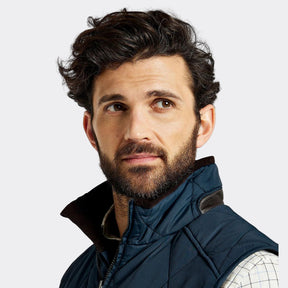 Man wearing a blue vest on a white background