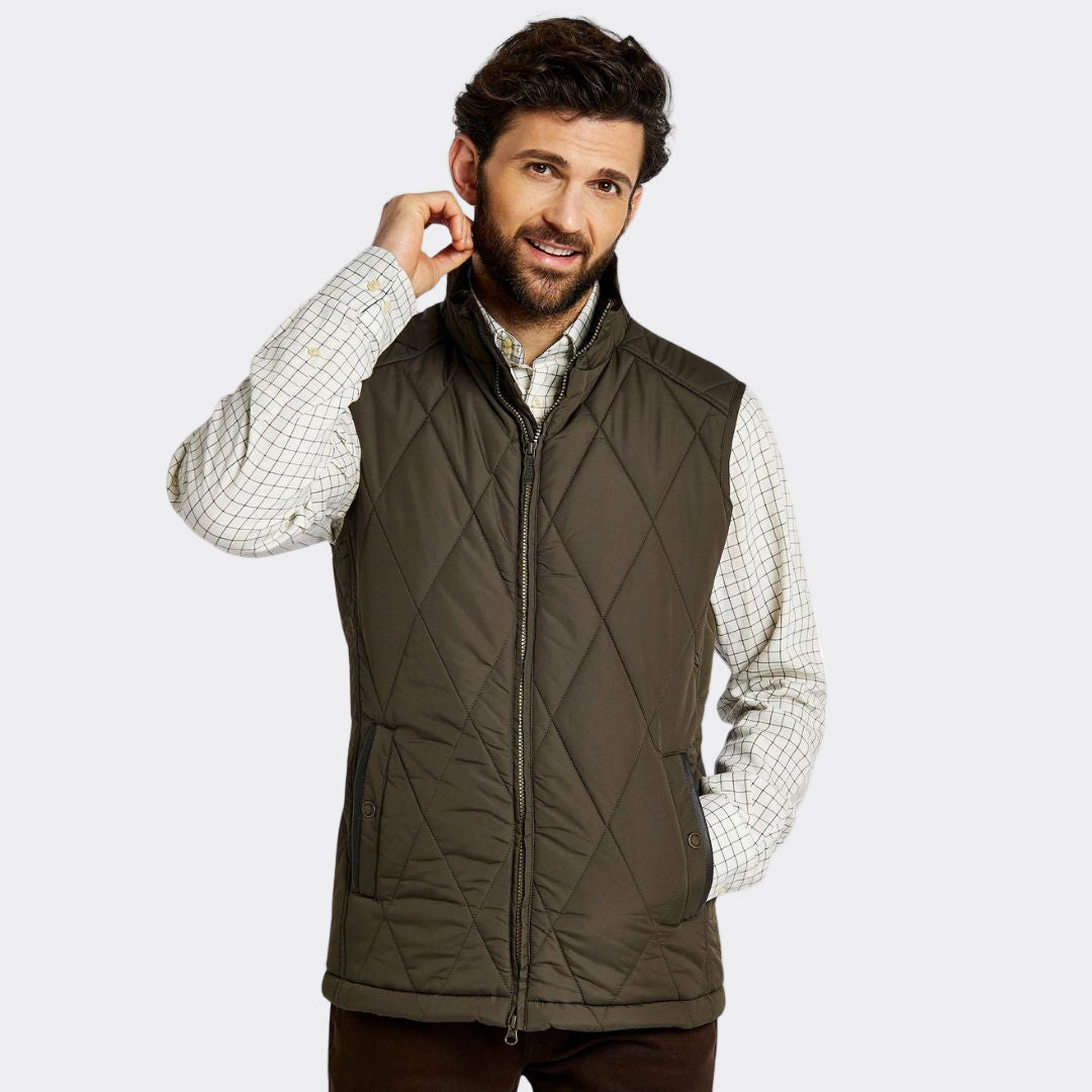 Man wearing a quilted vest on a white background