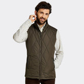 Man wearing a quilted vest on a white background