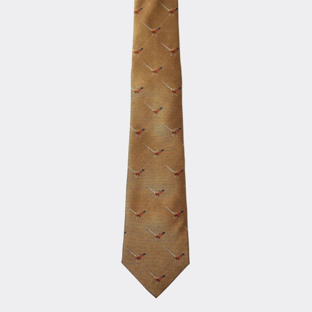 Gold tie with pheasant pattern on a white background