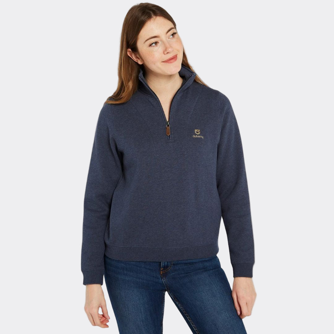Woman wearing a navy blue pullover with a logo on a white background