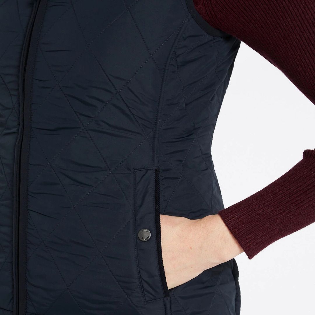 Navy quilted jacket with a person wearing burgundy sleeves on a white background