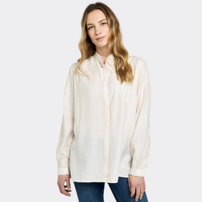 Woman wearing a white blouse and blue jeans on a white background