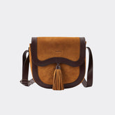 Brown leather crossbody bag with tassel on a white background