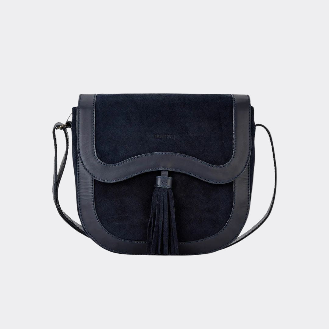 Black suede handbag with a tassel on a white background