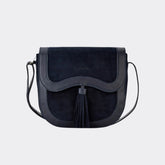 Black suede handbag with a tassel on a white background