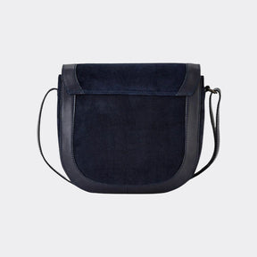 Black suede handbag with a strap on a white background