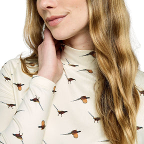 Woman wearing a cream-colored sweater with bird pattern, close-up of face and sweater.