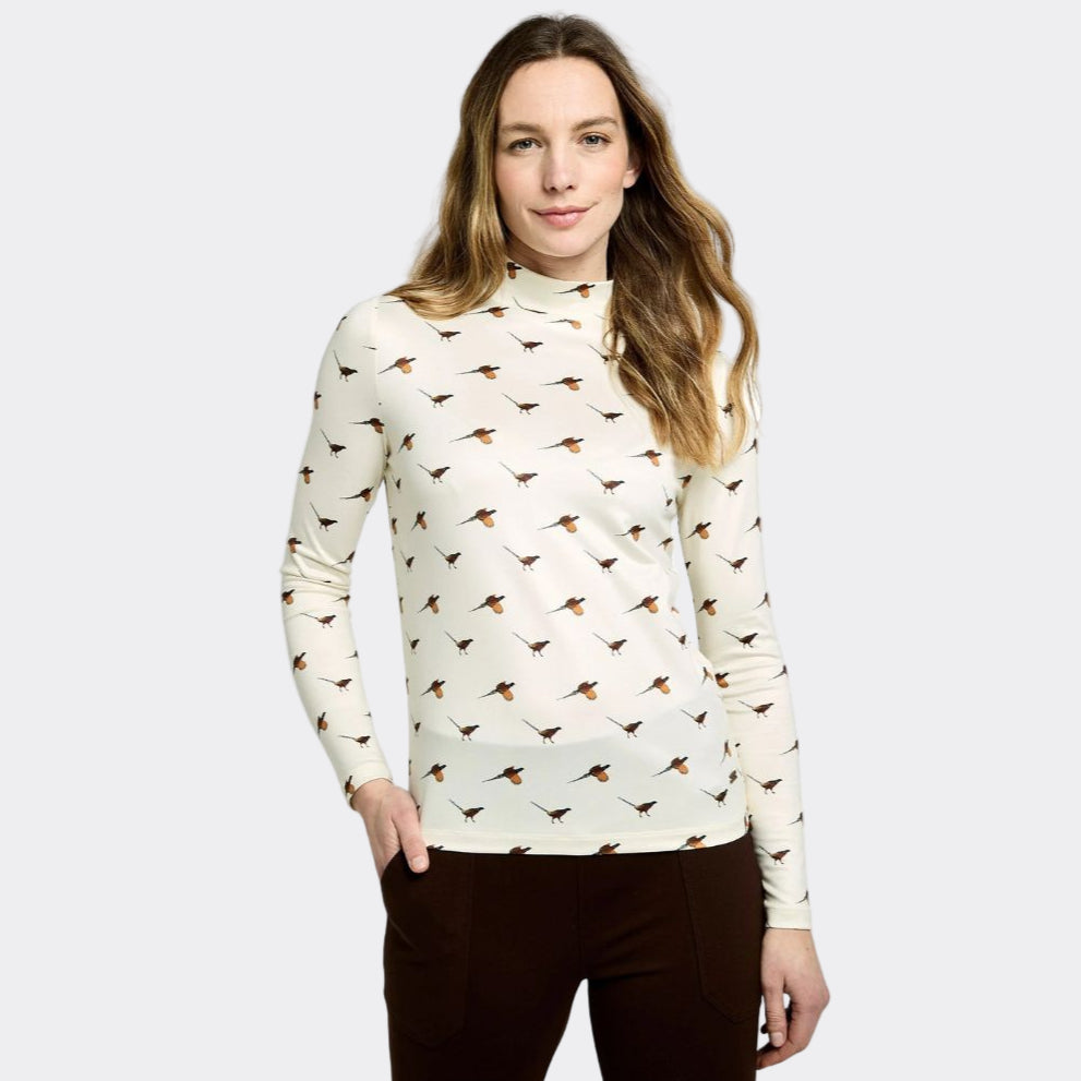 Woman wearing a cream-colored long-sleeve shirt with bird pattern on a white background