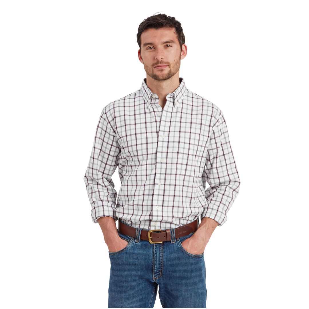 Man wearing a plaid shirt and jeans on a white background