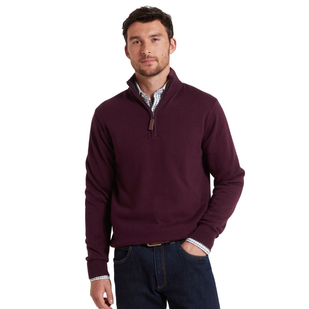 Man wearing a maroon pullover with a white background