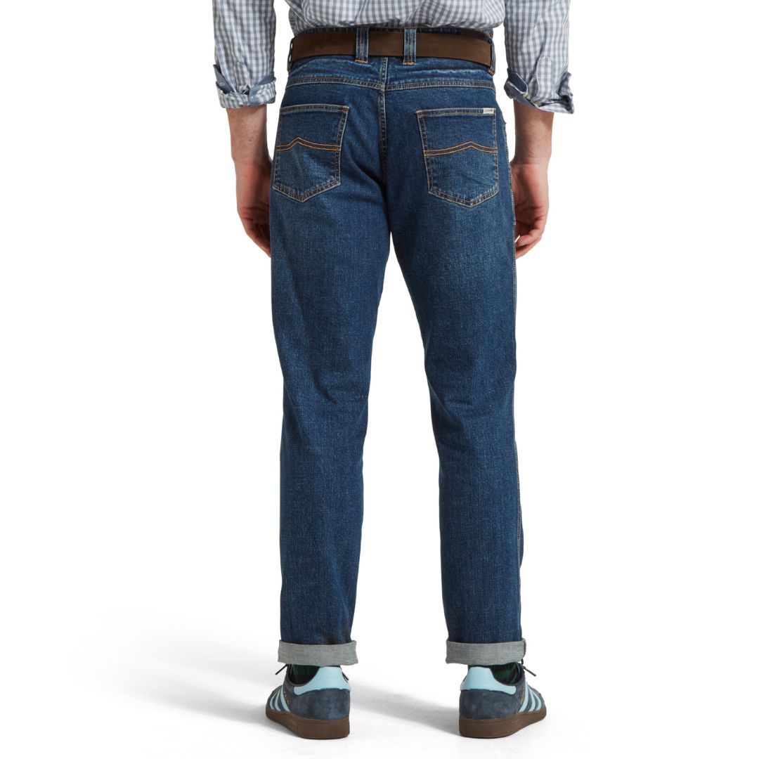 Person wearing blue jeans on a white background