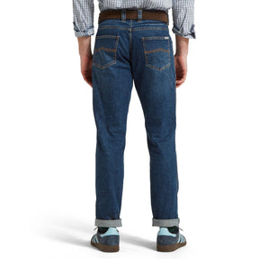 Person wearing blue jeans on a white background